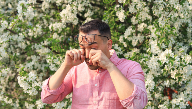 Image of a man rubbing his eyes